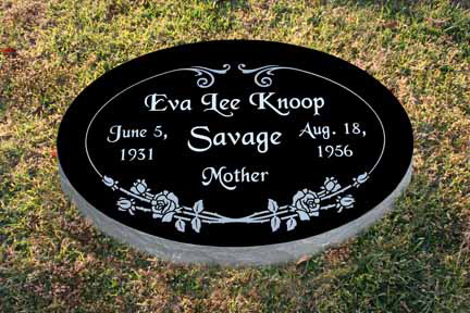 Oval black granite flat marker with white lettering and carved roses