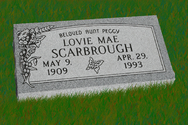 Flat grey granite grave marker lettered with a floral corner spray
