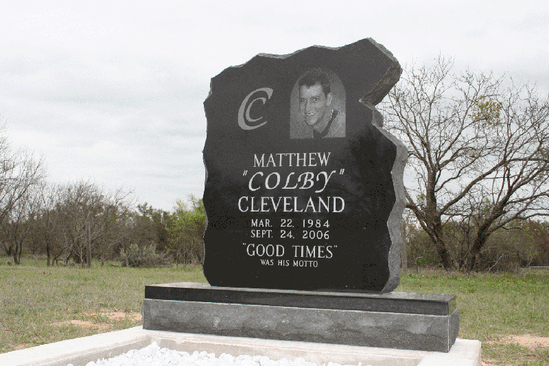 Black granite monument with a natural rough edge and a laser etched portrait