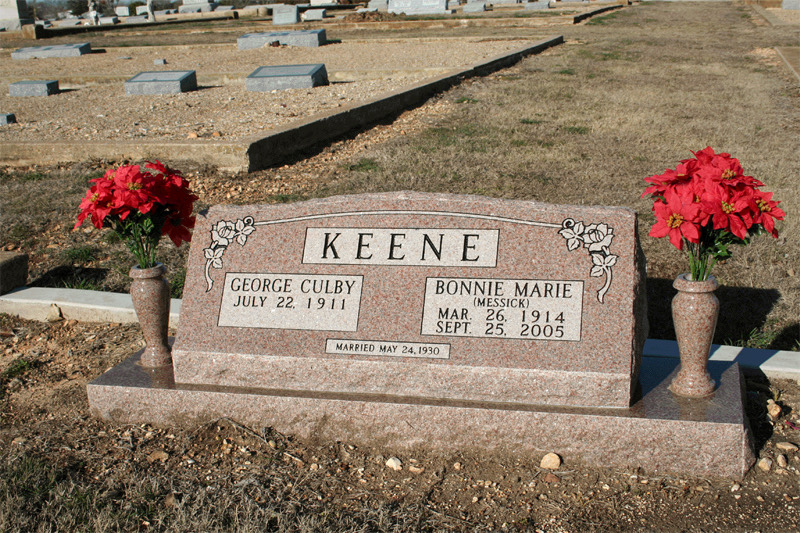 Rose granite companion monument with carved roses and matching granite vases