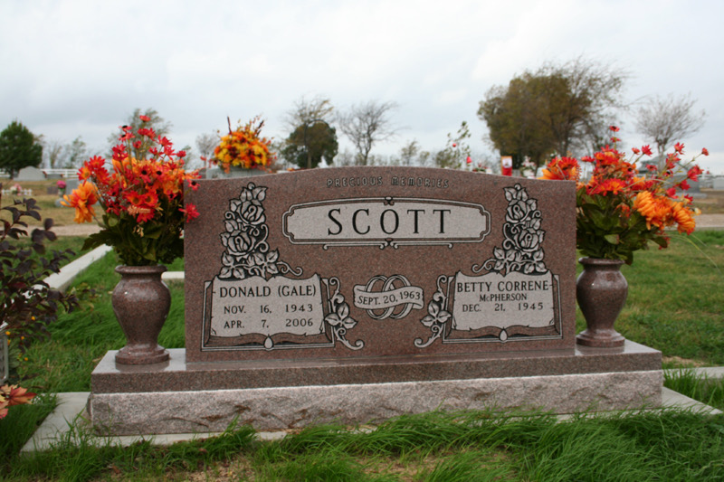 Rose granite companion upright monument with carved roses and twin vases